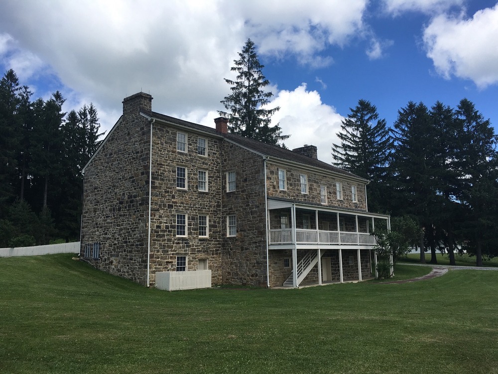 A stone tavern with a porch.