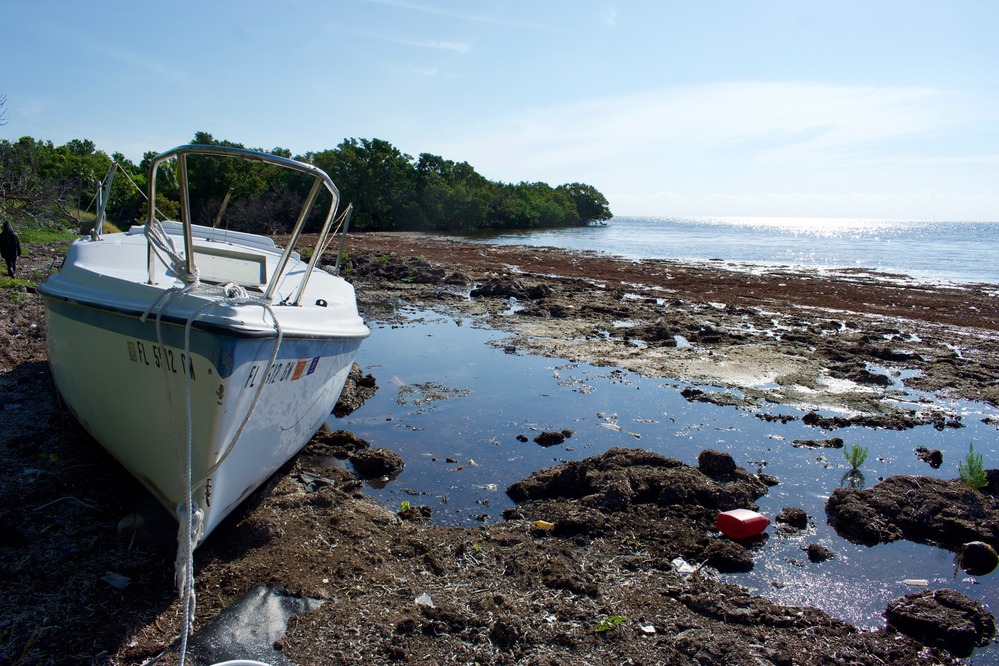 A shipwrecked sailboat on a rocky beach