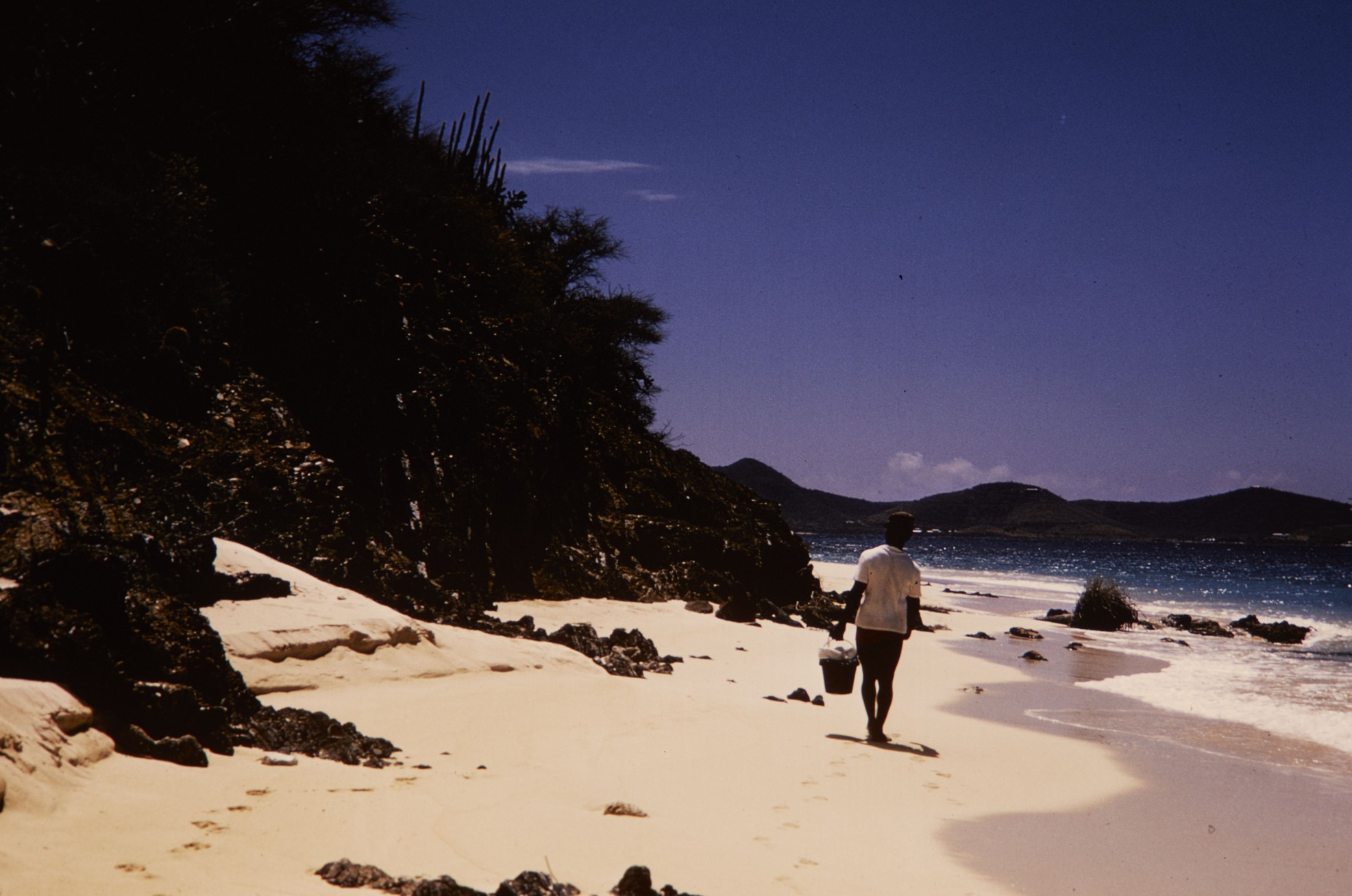 HFCA 1607_Visitors_154.jpg. Visitor walking along a beach at Buck Island Reef National Monument.