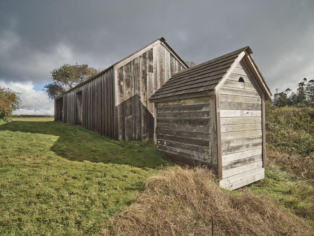 Exterior view of a small wooden structure. The outer sheds of the Ferry House.
