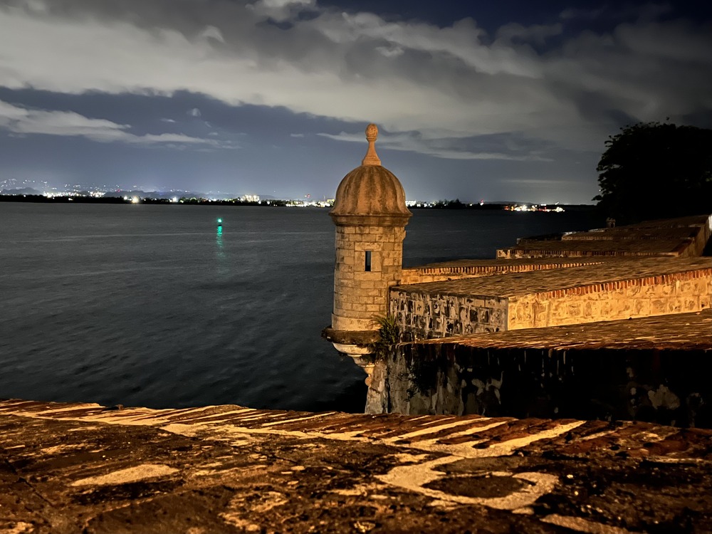 A Spanish sentry box on a stone wall at night 